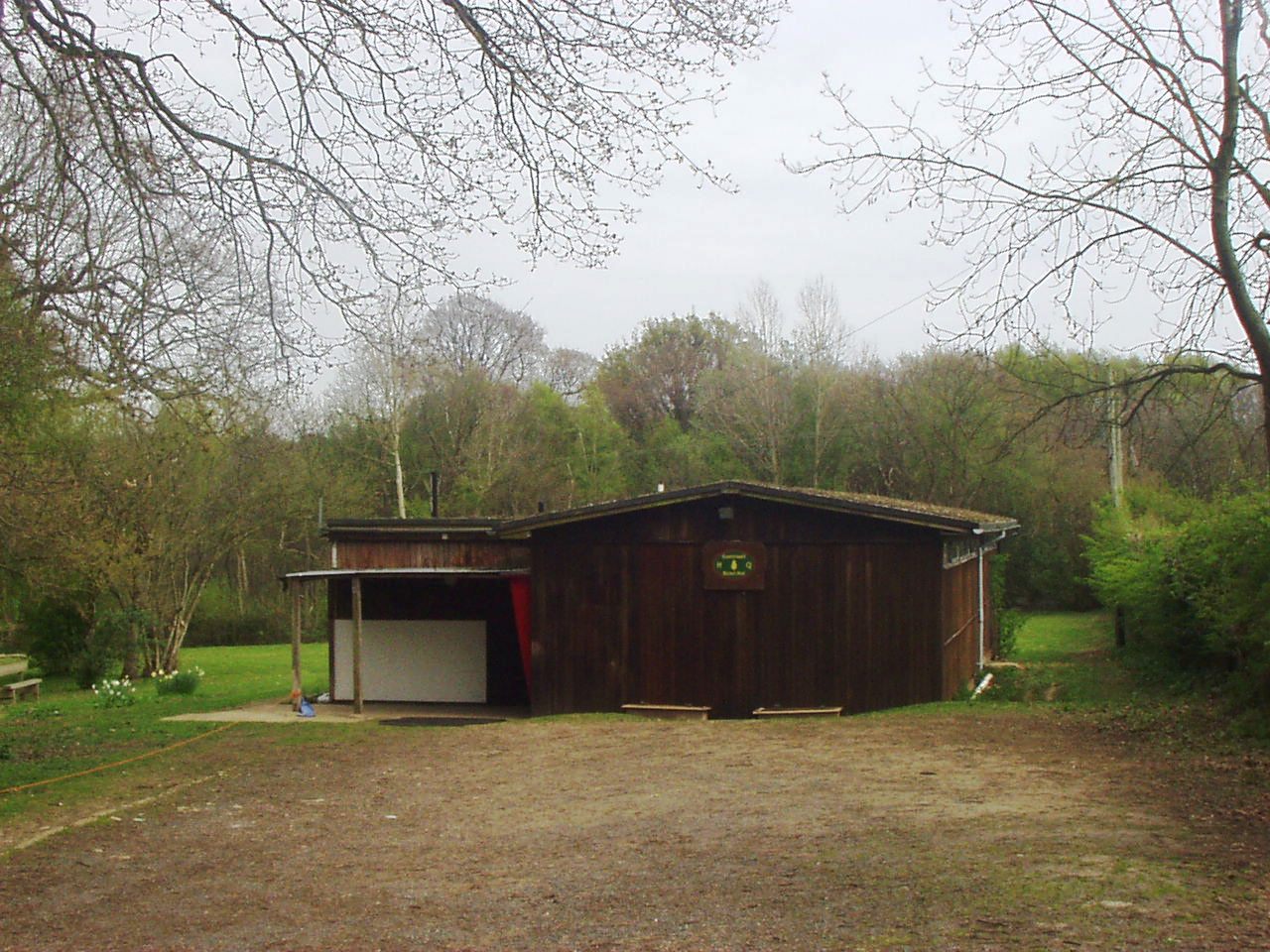 The Guestwell hut in spring, with woodland behind